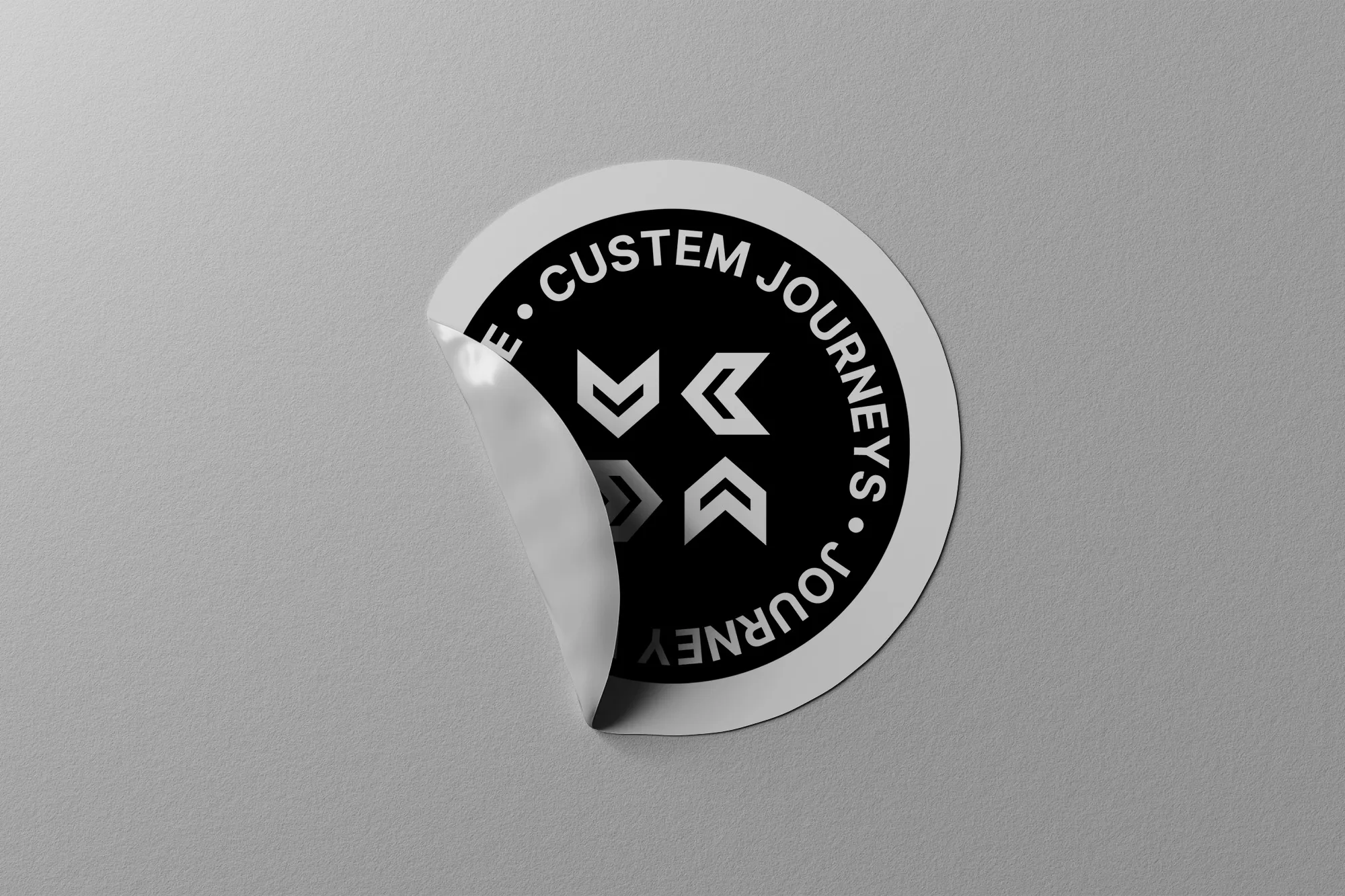 Partially peeled up circular sticker featuring the cuSTEM Journeys badge design